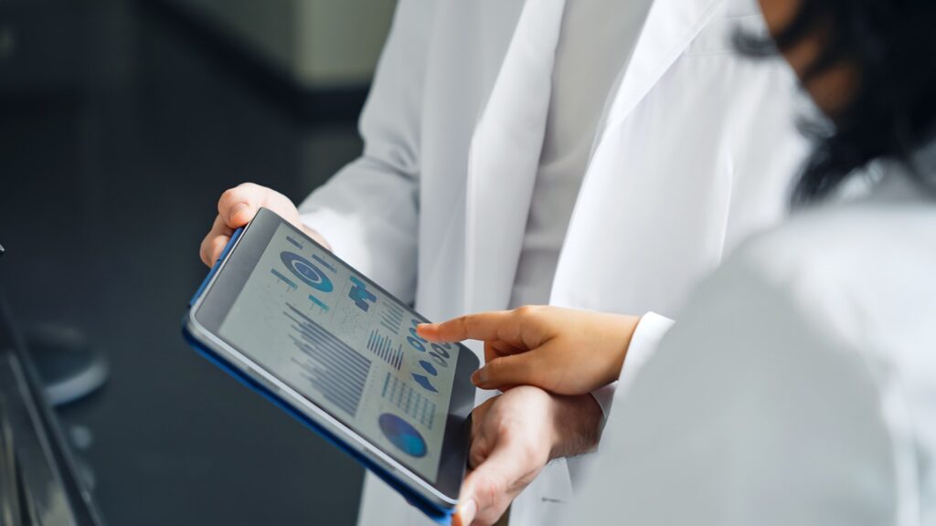 A,Group,Of,Researchers,Looking,At,A,Tablet,Screen.